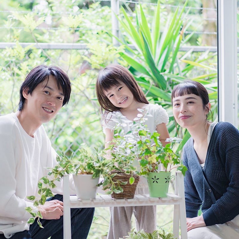 An Asian family with plants